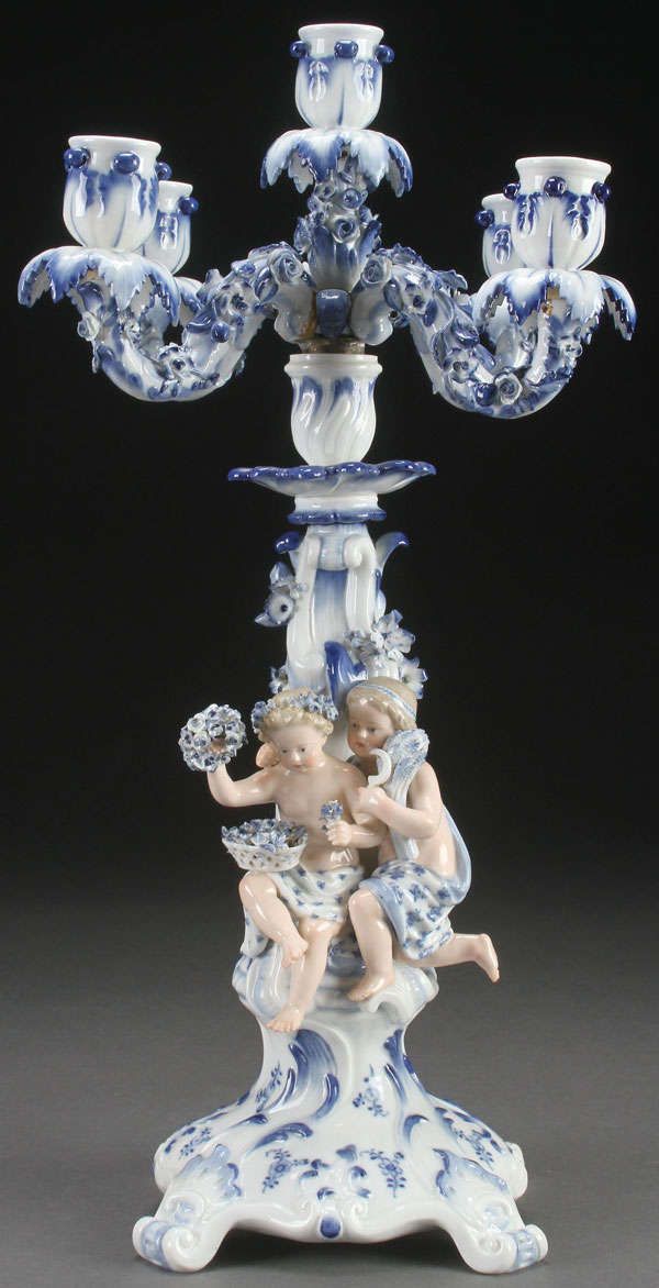 A MEISSEN BLUE AND WHITE FIGURAL CANDELABRA, LATE 19TH CENTURY. With applied figures and floral