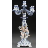 A MEISSEN BLUE AND WHITE FIGURAL CANDELABRA, LATE 19TH CENTURY. With applied figures and floral