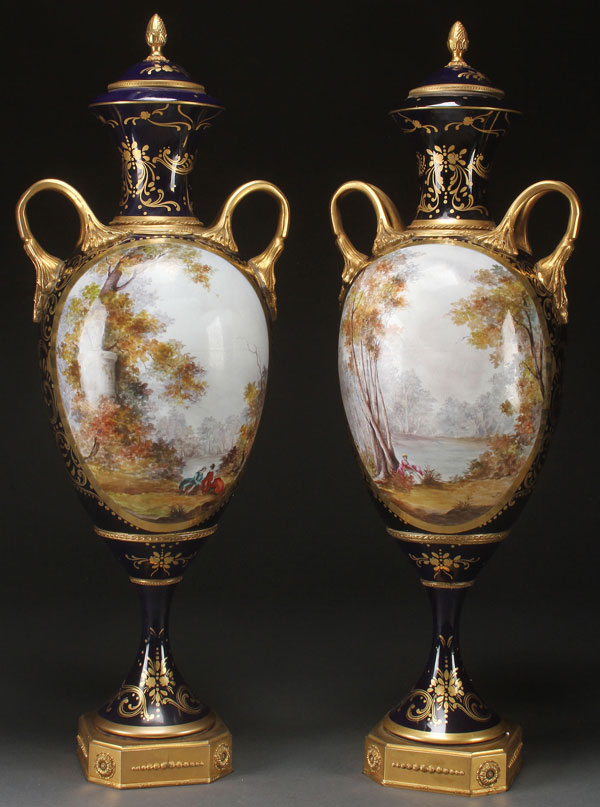 A LARGE PAIR OF SEVRES STYLE HAND PAINTED PORCELAIN AND GILT BRONZE COVERED URNS, LATE 19TH