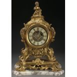 A FRENCH LOUIS XVI STYLE GILT BRONZE CLOCK, CIRCA 1900. The Rococo form corseted case surmounted by