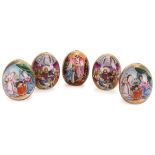 A GROUP OF FIVE RUSSIAN PORCELAIN EASTER EGGS, CIRCA 1915. The front of each painted with different