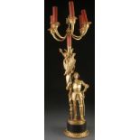 A FRENCH GILT BRONZE GOTHIC REVIVAL FIGURAL CANDELABRA OF A PALACE GUARD, 19TH CENTURY. Dressed in