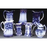 A GROUP OF SEVEN VICTORIAN FLOW BLUE PITCHERS. Including “Pansy” by Brown & Steventon, “Trent” by B