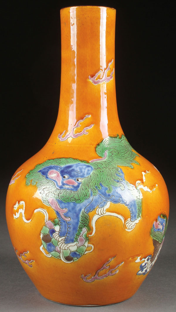 A CHINESE SANCAI GLAZED BOTTLE VASE, 19TH CENTURY. Decorated with temple lions in green, blue and