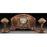 A FRENCH BRONZE MOUNTED MARBLE ART DECO CLOCK GARNITURE, CIRCA 1925. The domed rectangular “Basque