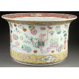 A LARGE CHINESE ENAMELED PORCELAIN CACHE POT. Of cylindrical form with flared everted rim decorated