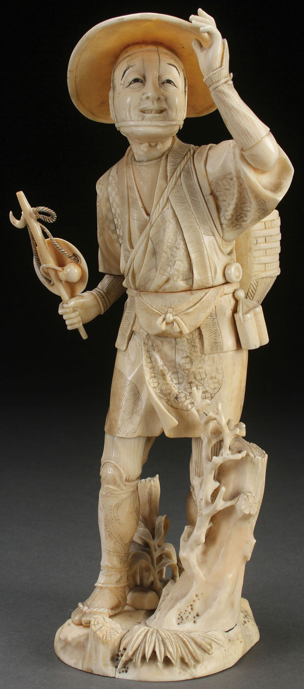 A LARGE JAPANESE CARVED IVORY OKIMONO OF A JOYFUL TRAVELER, MEIJI PERIOD. Fully carved in the round