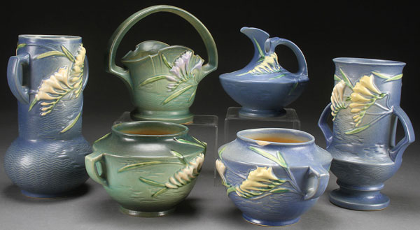 A COLLECTION OF SIX ROSEVILLE “FREESIA” ART POTTERY VASES, CIRCA 1945. In assorted shapes and