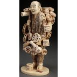 A FINE JAPANESE CARVED IVORY OKIMONO OF A STREET MERCHANT, PROBABLY MEIJI PERIOD. Well carved in