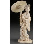 A VERY FINE JAPANESE CARVED IVORY OKIMONO OF A GEISHA, MEIJI PERIOD. Depicted with a windswept gown