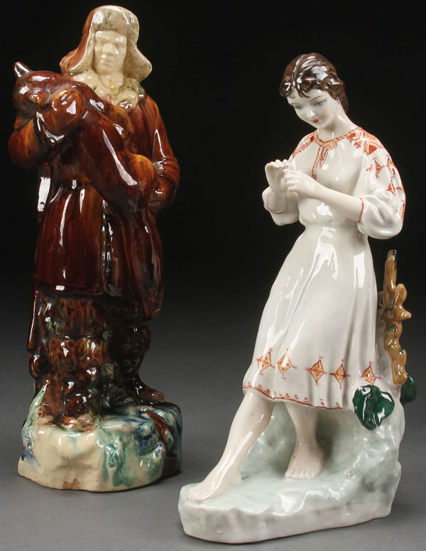 A PAIR OF RUSSIAN SOVIET GLAZED FIGURES, CIRCA 1950. Depicting a glazed ceramic hunter with fox,