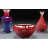 A CHINESE RED AND FLAMBÉ GLAZED PORCELAIN GROUP. Comprising a fine flambé decorated baluster vase,