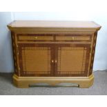 A 20th Century Side Cabinet with two drawers above two panelled doors raised upon a plinth,