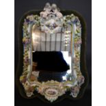 A Meissen Porcelain Large Wall Mirror with Putti Surmount above a cartouche hand painted with