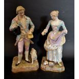 A Pair of Meissen Porcelain Figures in the form of a Lady and Gentleman feeding a Dog and feeding