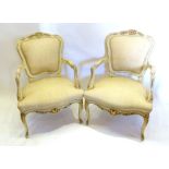 A Pair of French Louis XVI Style Cream Painted and Gilded Salon Armchairs with partly upholstered