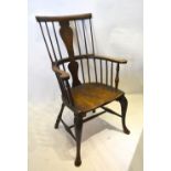 An Early 19th Century Elm Windsor Armchair with a shaped splat and spindle back above a panel seat