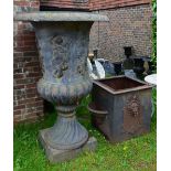 An Early 19th Century Large Cast Iron Garden Urn decorated in relief with classical figures upon a