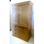 A 19th Century Pine Press Cupboard, the moulded cornice above two panelled doors,