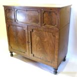 A Regency Mahogany Secretaire Cabinet with a centrally fully fitted secretaire drawer flanked by