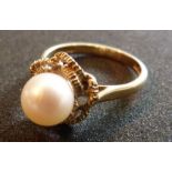 A 9ct gold ring with a single pearl with