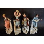 A Set of Four Capodimonte Figures all mounted upon stairs beside pillars,