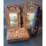 A Pair of Chinese Carved Wooden Picture Frames containing watercolours,