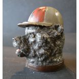 A Patinated Bronze Inkwell in the form of a Dog's Head, the cover in the form of a cap,