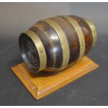 A Treen String Box In The Form Of A Brass Bound Barrel Upon A Stand