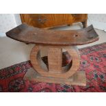 A Late 19th Early 20th Century African Carved Hardwood Stool of Shaped Form with a circular carved