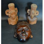 A Bali Carved Wooden Mask together with a pair of similar redwood busts in the form of girls