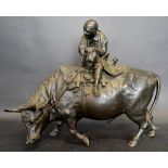 A Meiji Period Patinated Bronze Model In The Form Of A Man Smoking A Pipe Upon A Bull,