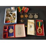 A Group of Four World War II Medals to include a War Medal 3945,