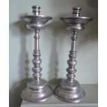 A Pair of Spanish Pewter Candlesticks, each a knopped stem and circular stepped base,