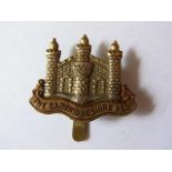 The Cambridgeshire Regiment Officers Territorial Forage Cap Badge: 1908 (Bi-metal, slider) Maker J.