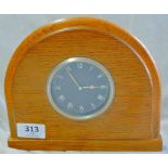 A Clock-Which has been taken from the dashboard of a vintage motor car and mounted in an oak display