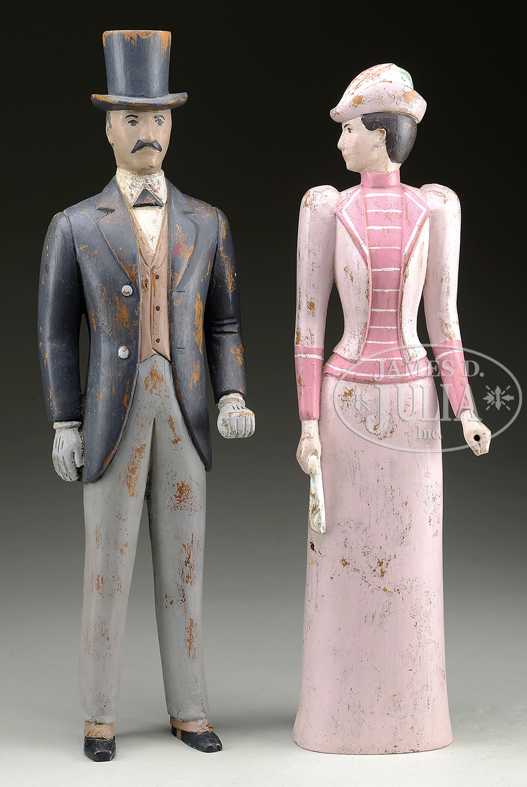 TWO CARVED AND PAINTED WOOD FIGURES. 20th century. Pair outfitted in formal costume, woman in