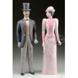 TWO CARVED AND PAINTED WOOD FIGURES. 20th century. Pair outfitted in formal costume, woman in
