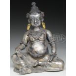 SILVERED COPPER ALLOY SEATED FIGURE OF KUBERA. 17th/18th century, Tibet. Seated figure of a