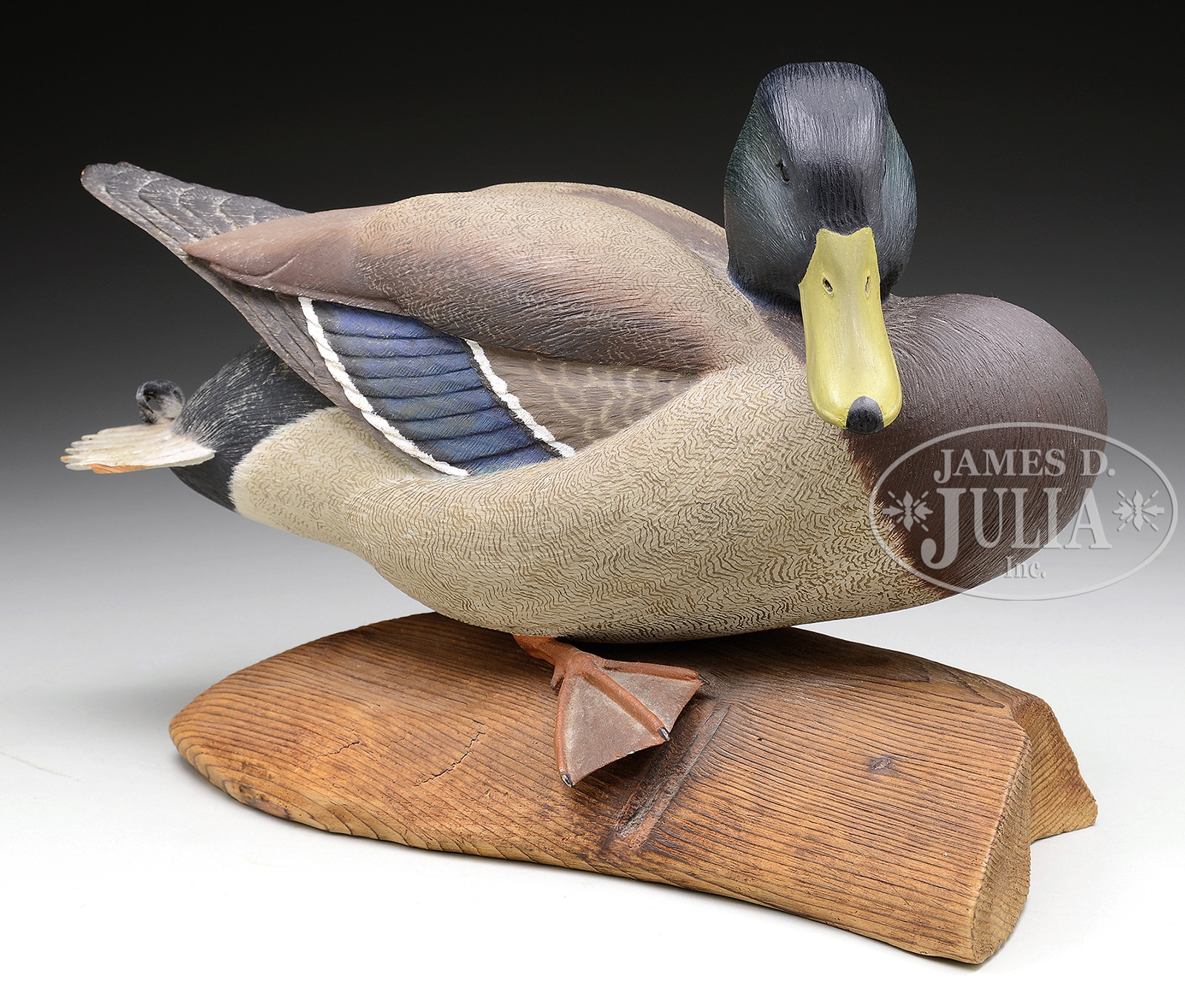 FINE LIFELIKE CARVED MALLARD ON LOG STAND. Second half 20th Century, New England. This nicely