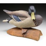 FINE LIFELIKE CARVED MALLARD ON LOG STAND. Second half 20th Century, New England. This nicely