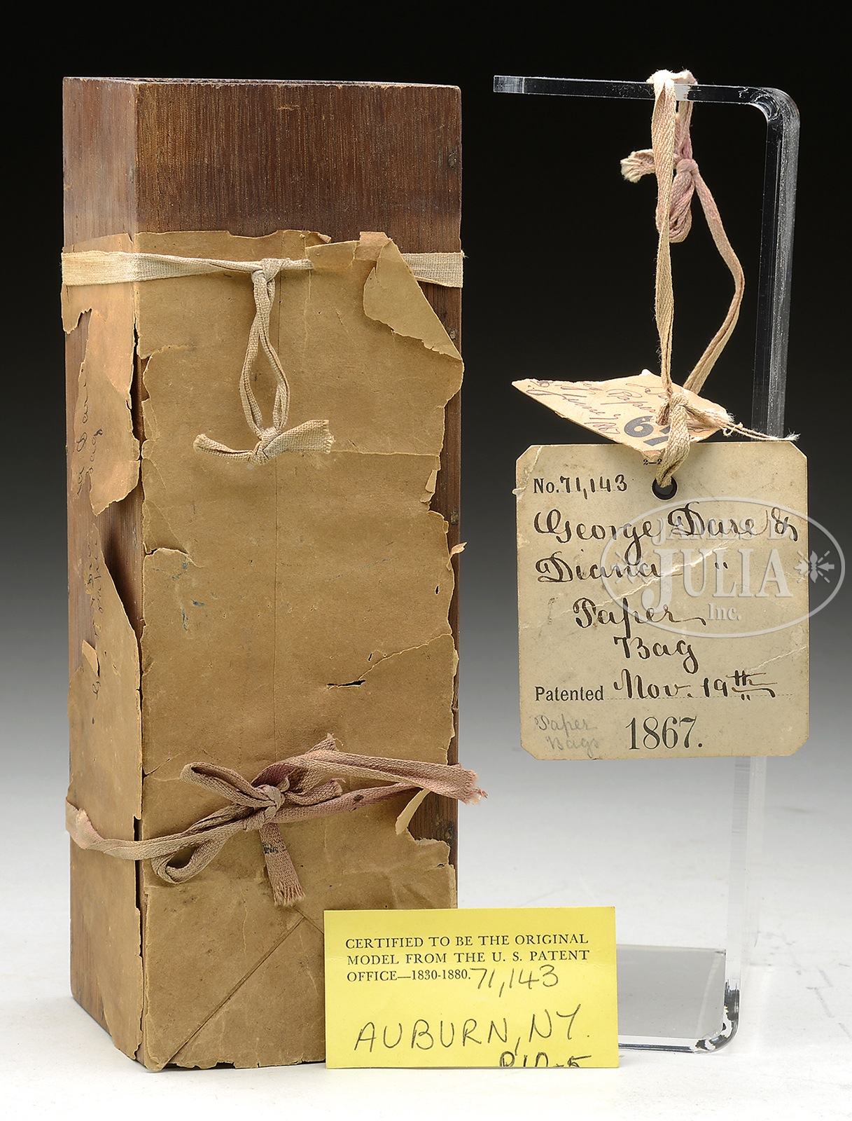 PATENT MODEL FOR A PAPER BAG. The remnants of the paper bag is tied around a wood box. The