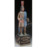 CARVED CIGAR STORE INDIAN. American 20th century. Depicted clasping a bundle of cigars in proper