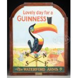COLORFUL PAINTED WOOD GUINNESS SIGN AND LARGE AMBER GLASS GUINNESS BOTTLE. Large sign having over