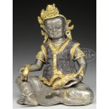 SILVERED COPPER ALLOY FIGURE OF KUBERA. 19th/20th century, Tibet. Seated figure in base silver,