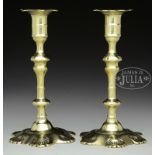 PAIR OF QUEEN ANNE SHELL DECORATED PETAL BASE BRASS CANDLESTICKS.