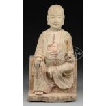 CARVED STONE STATUE OF SEATED FIGURE.