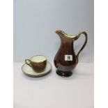 ROCKINGHAM, treacle glazed gilt heightened milk jug with Griffin factory mark with matching  cup and