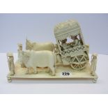 ANTIQUE IVORY CARVING, Indian carved ox drawn carriage, on 9" platform base (requires restoration)