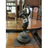 BRONZE FIGURE LAMP BASE, the support decorated putti with arm aloft on circular base, 11" high